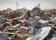 <p>A shopkeeper surveys the wreckage of shops destroyed by a blast in a market in the capital Mogadishu, Somalia Feb. 19, 2017. (Photo: Farah Abdi Warsameh/AP) </p>