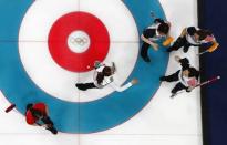 Curling - Pyeongchang 2018 Winter Olympics - Women's Round Robin - U.S. v South Korea - Gangneung Curling Center - Gangneung, South Korea - February 20, 2018 - Kim Eun-jung, Kim Kyeong-ae, Kim Seon-yeong and Kim Cho-hi of South Korea celebrate winning as Tabitha Peterson of the U.S. walks past. REUTERS/Cathal McNaughton