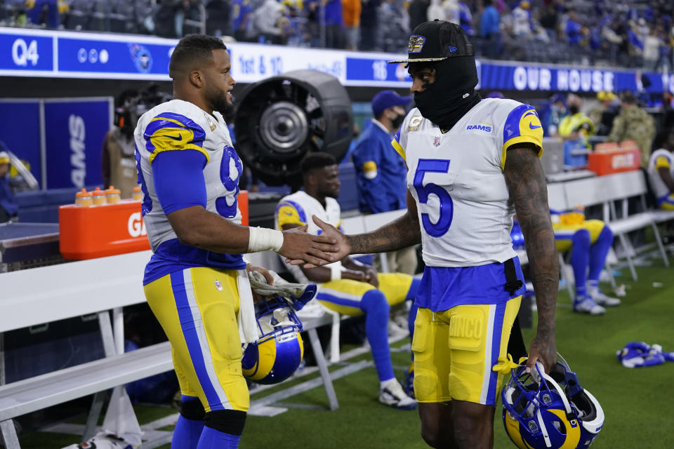 Los Angeles Rams cornerback Jalen Ramsey (5) greets defensive end Aaron Donald during the second half of an NFL football game against the Tennessee Titans, Sunday, Nov. 7, 2021, in Inglewood, Calif. (AP Photo/Marcio Jose Sanchez)
