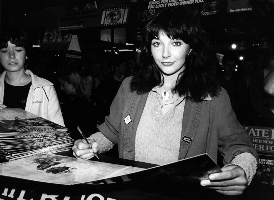 Kate Bush signing a vinyl copy of her album ‘Never For Ever’ in London, 1980 (Getty Images)