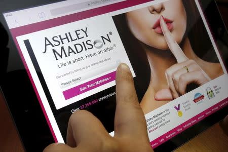 The homepage of the Ashley Madison website is displayed on an iPad, in this photo illustration taken in Ottawa, Canada July 21, 2015. REUTERS/Chris Wattie