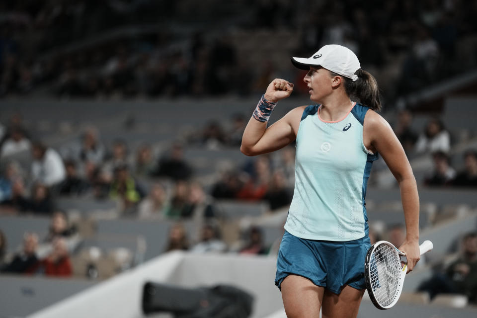 Poland's Iga Swiatek celebrate winning the first set during the first round match against Ukraine's Lesia Tsurenko at the French Open tennis tournament in Roland Garros stadium in Paris, France, Monday, May 23, 2022. (AP Photo/Thibault Camus)