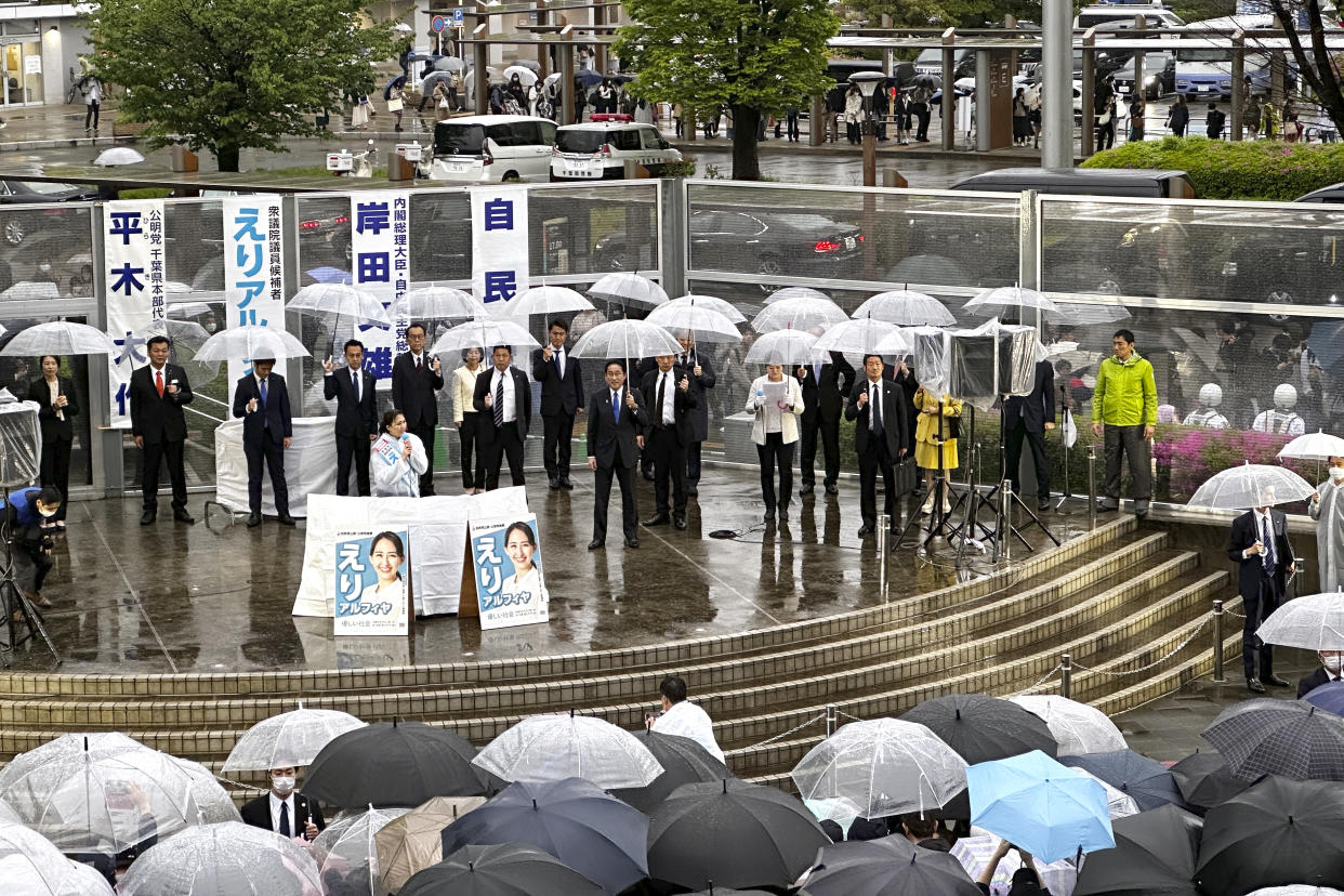 People listen one of candidate's stump speech as Japan's Prime Minister and President of the ruling Liberal Democratic Party Fumio Kishida accompanies during an election campaign for the upcoming unified local elections Saturday, April 15, 2023, in Urayasu, near Tokyo. (AP Photo/Richard Colombo)