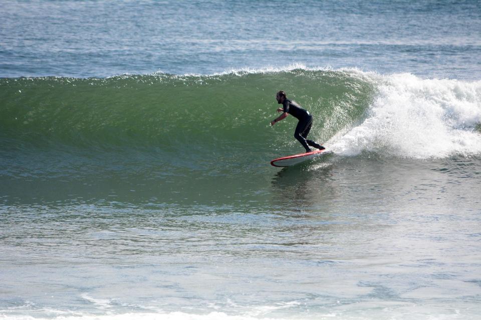 Surfer Cam MacLeod rides a wave at Fox Hill in Rye Thursday when conditions were ideal thanks to Hurricane Lee offshore.