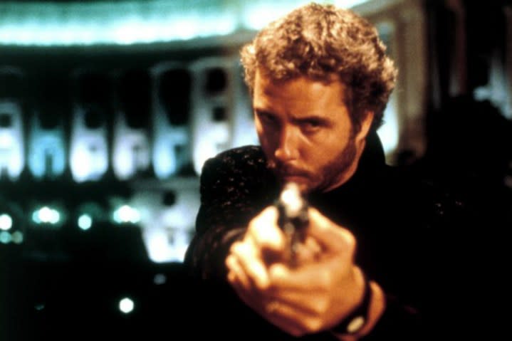 William Peterson points a gun and stares in Manhunter.