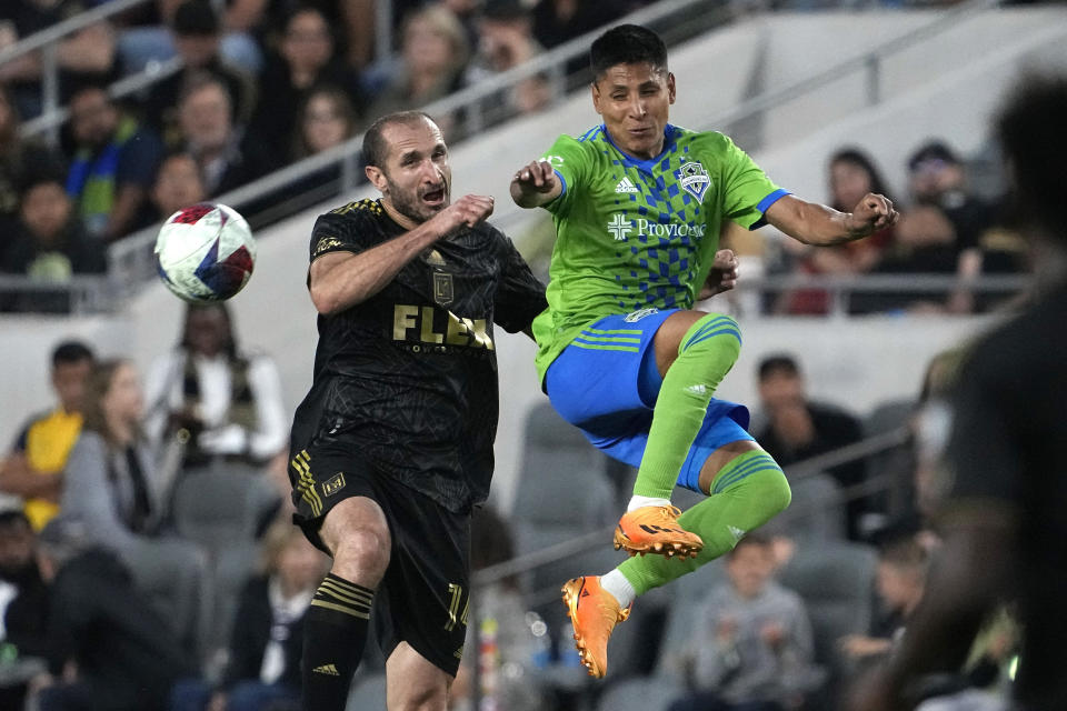 Los Angeles FC defender Giorgio Chiellini, left, and Seattle Sounders forward Raul Ruidiaz go after the ball during the first half of a Major League Soccer match Wednesday, June 21, 2023, in Los Angeles. (AP Photo/Mark J. Terrill)