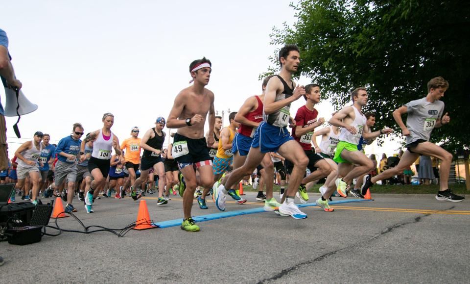 Runners in the 5-kilometer and 10K races begin the Hungry Duck Run in downtown Brighton Monday, July 4, 2022.