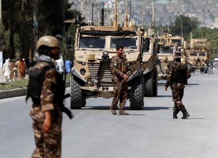 Afghan security forces and foreign troops arrive at the site of a suicide attack in Kabul