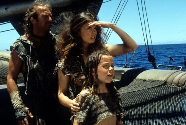 Kevin Costner, Jeanne Tripplehorn and Tina Majorino look to the horizon in a scene from the film "Waterworld" in 1995.<p><a href="https://www.gettyimages.com/detail/159836707" rel="nofollow noopener" target="_blank" data-ylk="slk:Archive Photos/Getty Images;elm:context_link;itc:0;sec:content-canvas" class="link ">Archive Photos/Getty Images</a></p>