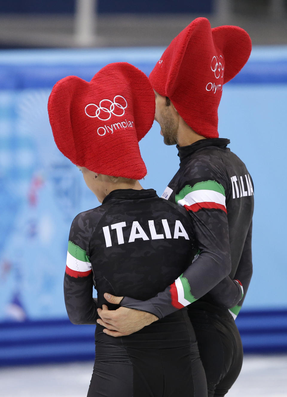 Arianna Fontana of Italy and Anthony Lobello of Italy wear Valentines Day themed hats during a short track speedskating practice session at the Iceberg Skating Palace during the 2014 Winter Olympics, Friday, Feb. 14, 2014, in Sochi, Russia. (AP Photo/Darron Cummings)