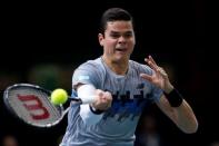 Milos Raonic of Canada returns a shot against Switzerland's Roger Federer during their quarter-final match at the Paris Masters tennis tournament at the Bercy sports hall in Paris, October 31, 2014. REUTERS/Benoit Tessier