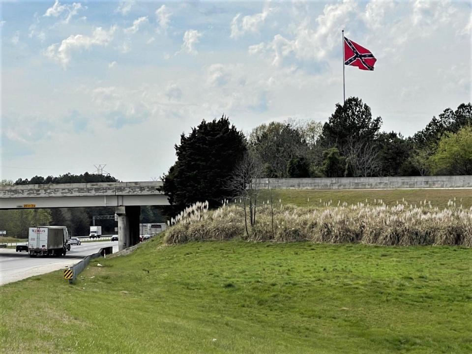 Five months since being raised, the Confederate flag is still flying high atop a 120-foot flagpole along Interstate 85 in Spartanburg County as a lawsuit works its way through the courts.