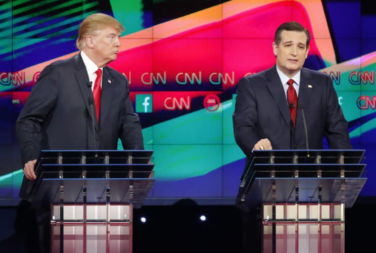 Ted Cruz, right, speaks as Donald Trump looks on during a CNN primary debate. (Photo: John Locher/AP)