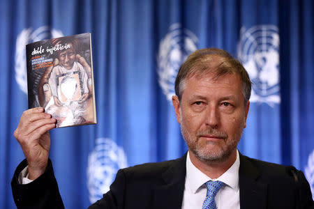 Jan Jarab, the UN High Commissioner for Human Rights in Mexico, holds a book during a news conference for the delivery of a UN report about the case of the 43 Ayotzinapa College Raul Isidro Burgos students in 2014, in Mexico City, Mexico March 15, 2018. REUTERS/Edgard Garrido