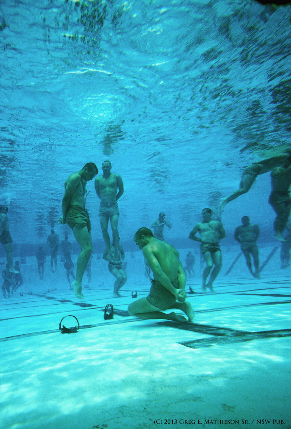 It obvious that SEALs undergo a lot of water training.  A program that was developed during the Vietnam war was that of drown proofing.  A program that builds great confidence in the students of being able to survive in deep water.  In this part of training, students have their hands tied behind their backs and descend to the bottom of the pool to recover this face mask with in their teeth. Photo: (C) 2011 Greg E. Mathieson Sr. / NSW Publications, LLC