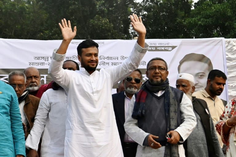 Colourful Bangladeshi cricketer Shakib Al Hasan (C) who won his seat in elections on Sunday, pictured on the campaign trail last month (Munir UZ ZAMAN)