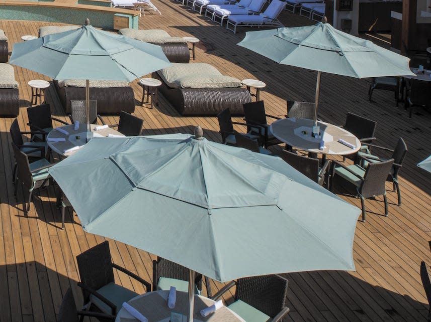 A pool deck with umbrellas.