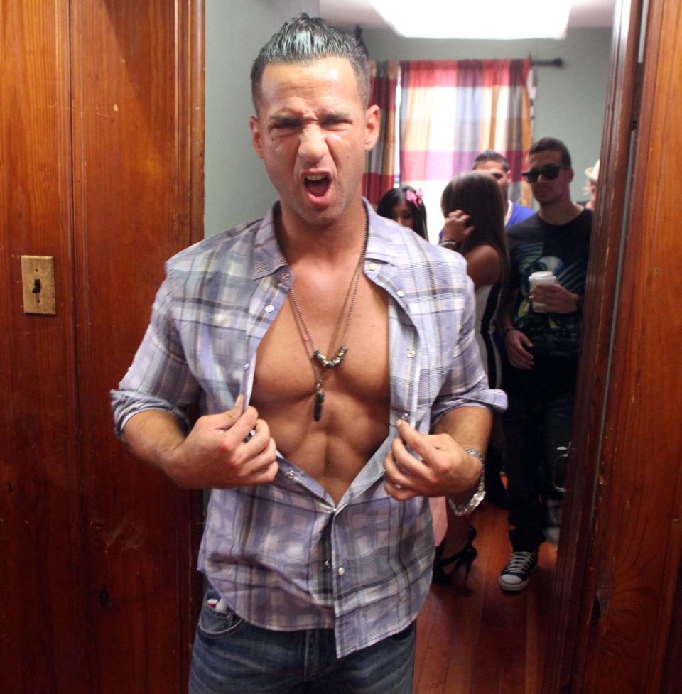 Mike "The Situation" Sorrentino gives a flash of his famous abs at the "Jersey Shore" house in Seaside Heights in 2011.