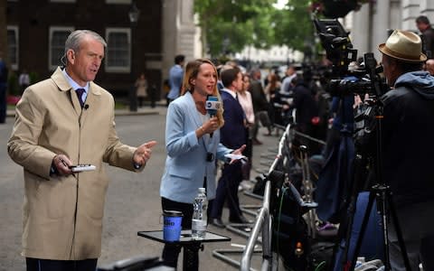 News anchors deliver reports to television cameras in Downing Street - Credit: Chris J Ratcliffe/Bloomberg