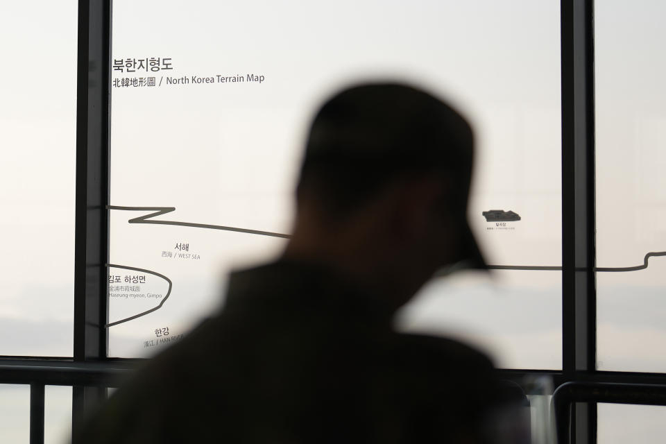A visitor stands near a map of North Korea at the unification observatory in Paju, South Korea, Tuesday, Nov. 21, 2023. North Korean leader Kim Jong Un said his country will launch three additional military spy satellites, build more nuclear weapons and introduce modern unmanned combat equipment in 2024, as he called for “overwhelming” war readiness to cope with U.S.-led confrontational moves, state media reported Sunday, Dec. 31, 2023.(AP Photo/Lee Jin-man)