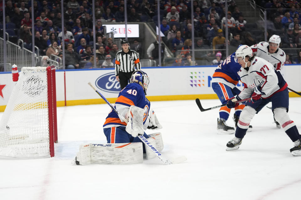Washington Capitals right wing T.J. Oshie (77) scores past New York Islanders goaltender Semyon Varlamov (40) during the first period of an NHL hockey game Saturday, March 11, 2023, in Elmont, N.Y. (AP Photo/Mary Altaffer)