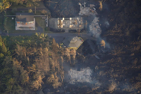 Lava destroys homes in the Kapoho area, east of Pahoa, during ongoing eruptions of the Kilauea Volcano in Hawaii, U.S., June 5, 2018. REUTERS/Terray Sylvester