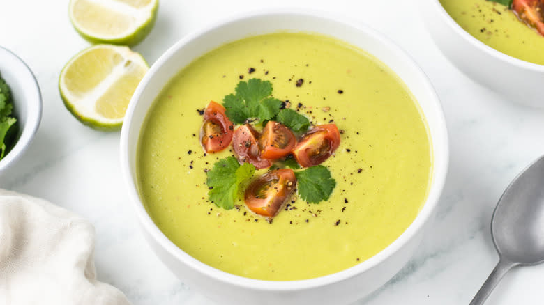 avocado soup in bowl with toppings