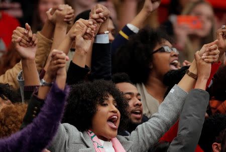 Protestors hold hands in the air as they yell at U.S. Republican presidential candidate Donald Trump during a campaign event in Radford, Virginia February 29, 2016. REUTERS/Chris Keane