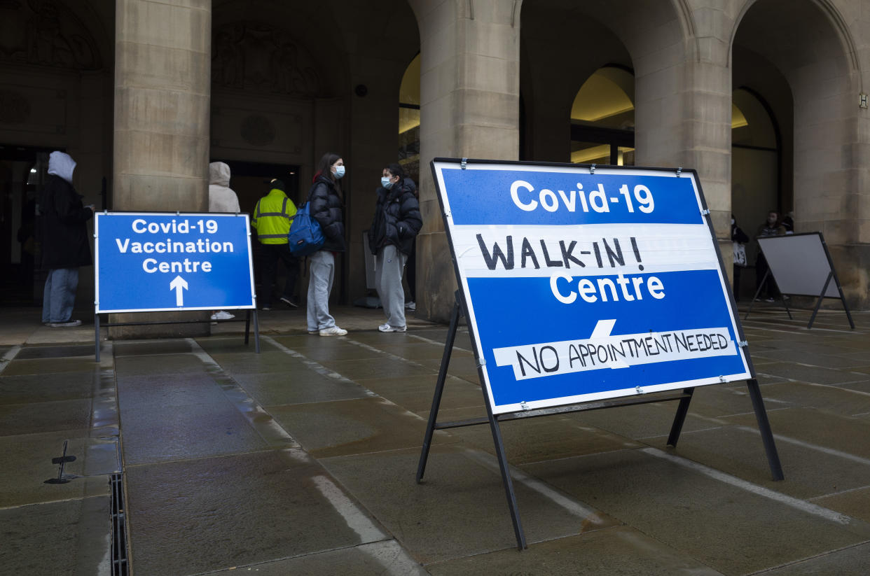 People, some wearing face masks to protect against Coronavirus, wait in line despite the bad weather at a walk-in Covid vaccination centre as the Office for National Statistics (ONS) reveals rates of Covid-19 infection rocketed to record breaking highs of 4.9 million people last week on 30th March, 2022 in Manchester, United Kingdom. With universal free testing in England coming to an end as of April, the public will now need to turn to high street retailers if they want to purchase a Coronavirus testing kit. (photo by Daniel Harvey Gonzalez/In Pictures via Getty Images)