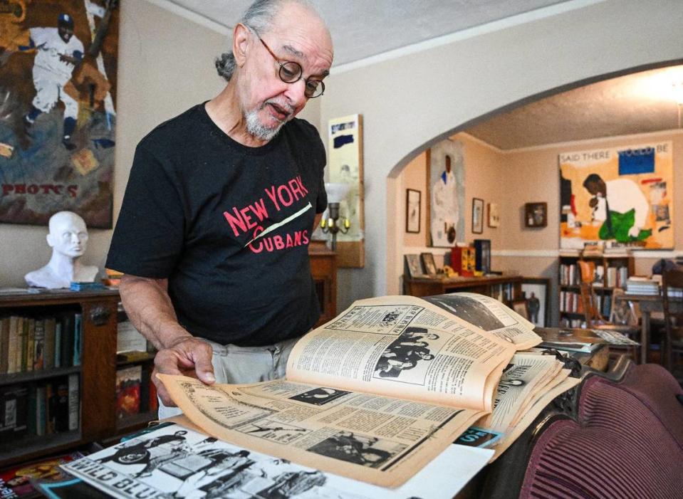 Fresno musician Glen Delpit looks through an old newspaper showing listings of various local bands who played at The Wild Blue Yonder music venue in the Tower District.