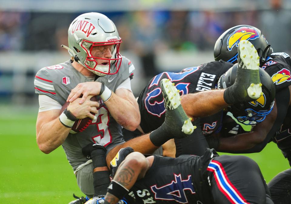 UNLV quarterback Matthew Sluka (3) is tackled by several Kansas Jayhawks during the first half of a Sept. 13, 2024 game at Children's Mercy Park.