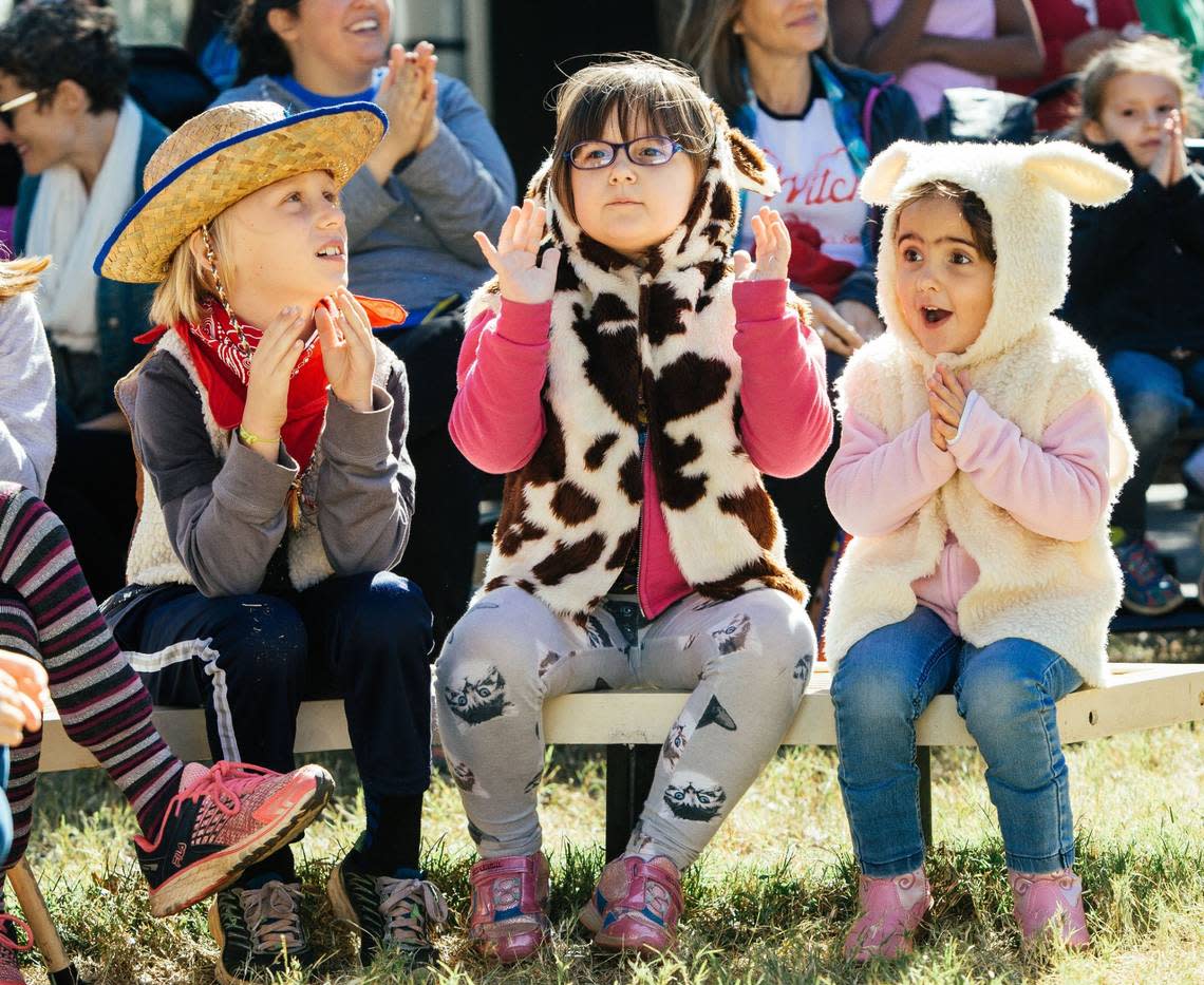 Kendall Walas, left, Jackie Jenkins, middle, and Emily, right, watch a stage show called The Magic Bean during the final day of the North Carolina State Fair in Raleigh, N.C. on Sunday, Oct. 23, 2016.