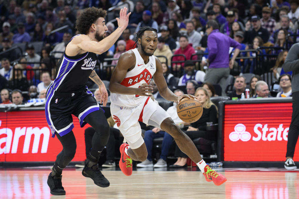 Sacramento Kings guard Chris Duarte, left, guards against Toronto Raptors guard Immanuel Quickley, right, during the first quarter of an NBA basketball game in Sacramento, Calif., Friday, Jan. 5, 2024. (AP Photo/Randall Benton)