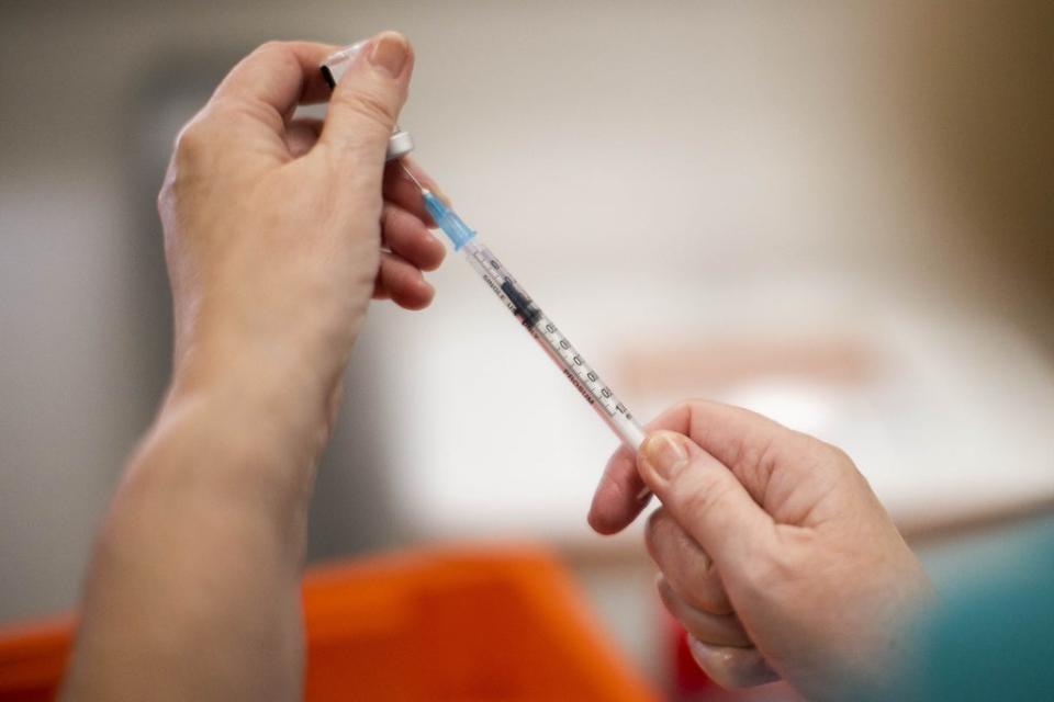 Vaccinator Rosie Buchanan prepares a vial of the Pfizer/BioNTech vaccine (PA) (PA Wire)
