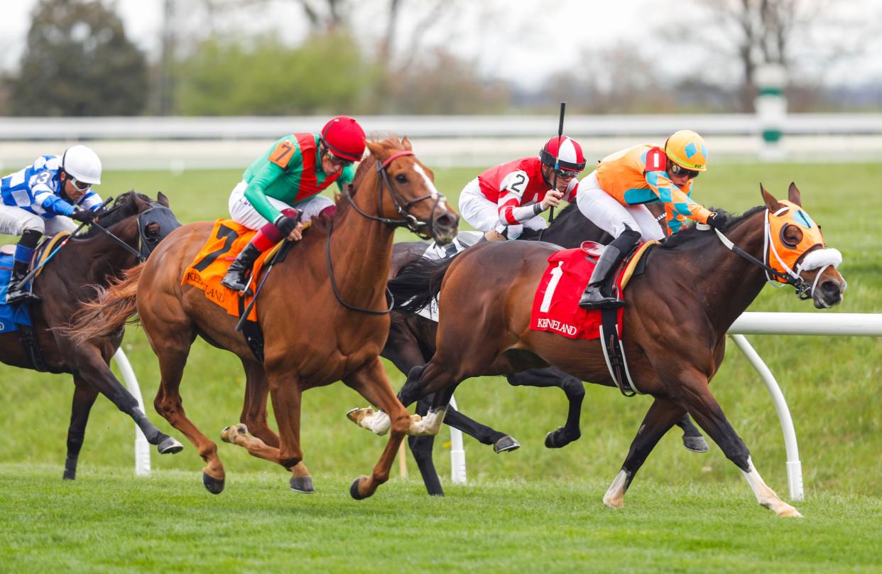 Hurricane Dream with Frankie Dettori overtakes Fancy Liquor (1) to win The Crestwood -- 4th race -- at the Spring Meet opening Friday at Keeneland.  April 7, 2023