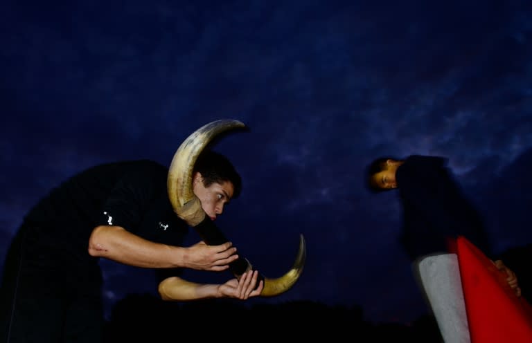 Two students practice with a red cape and bull's horns during an open air class at Marcial Lalanda bullfighting academy in Madrid's Casa de Campo park