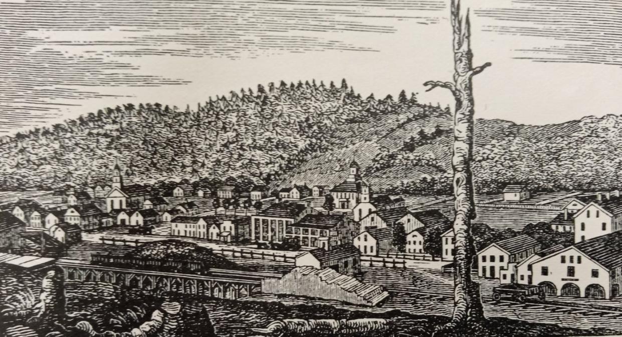 This is the earliest known rendering of Honesdale, done in 1843 and showing the wooden Wayne County courthouse in back. In the immediate foreground is the original Episcopal Church, and at far left is the former Presbyterian Church, both made of wood. Note how the artist shows Irving Cliff hidden by trees. Main Street (Front Street) is in view, as well as canal operations.