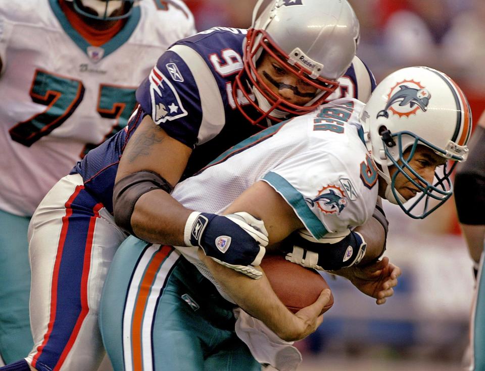 New England Patriots defensive lineman Richard Seymour (93) sacks Miami Dolphins quarterback Jay Fiedler during first-quarter action, Oct. 10, 2004, in Foxborough, Mass.