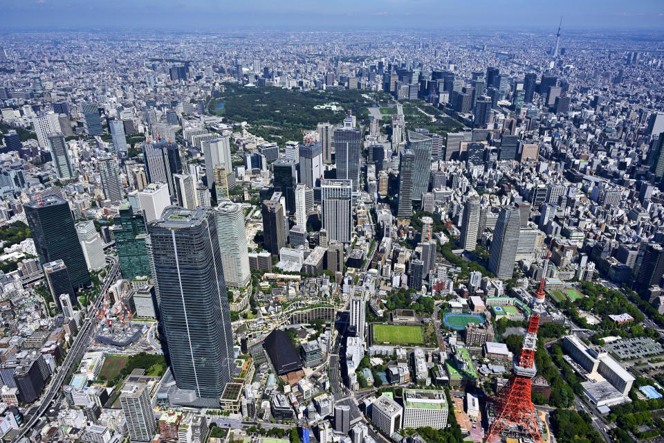 This aerial photo provided by Mori Building Co. shows Azabudai Hills, lower left, one of Mori's buildings planned to open in November, in Tokyo. Mori JP Tower, a 64 story, 325 meter-tall (1,067 foot tall) skyscraper that will be Japan’s tallest structure, is part of Mori Building's 600 billion yen ($6 billion) Azabudai Hills project. (Mori Building Co. via AP)