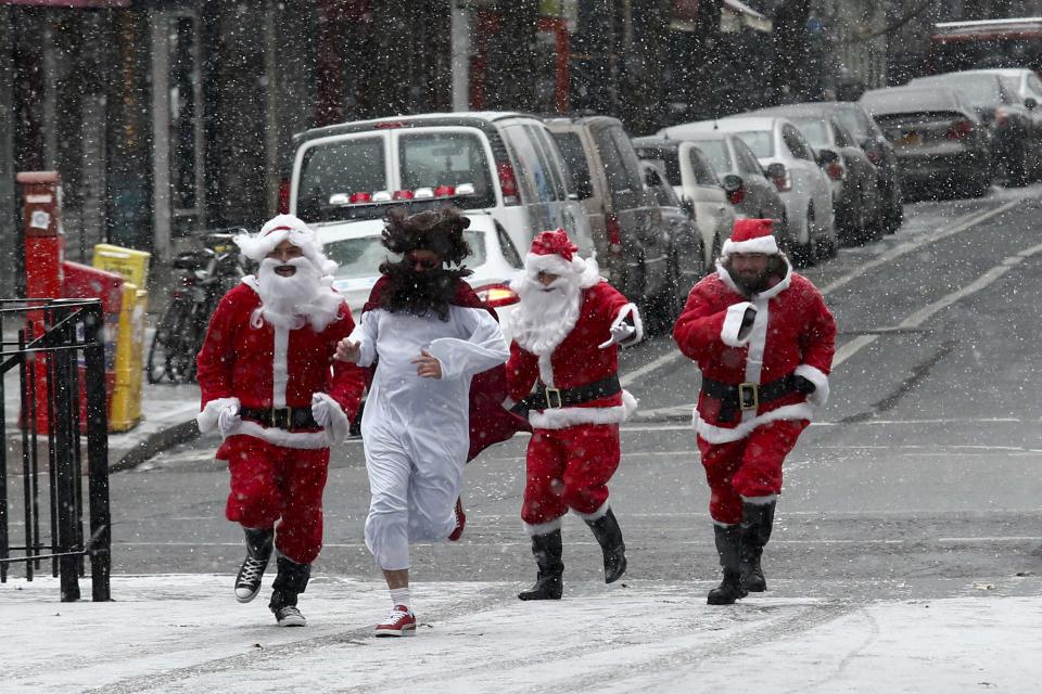 Revellers dressed as Santa Claus run in park during the SantaCon event in New York