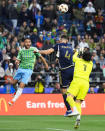 Seattle Sounders midfielder Cristian Roldan, left, looks on as the ball is cleared by Vancouver Whitecaps defender Ranko Veselinovic (4) and goalkeeper Yohei Takaoka (1) during the first half of an MLS soccer match Saturday, April 20, 2024, in Seattle. (AP Photo/Lindsey Wasson)