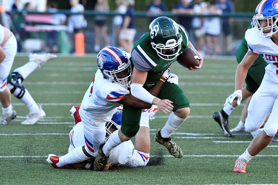 South Oldham’s Jeffery Burton (4) is brought down by Christian Academy Justin Ruffin (4) during the first half of their game at South Oldham High School, Friday, Aug. 19, 2022 in Crestwood Ky.