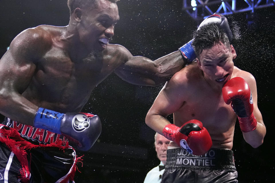 Jermall Charlo, left, hits Juan Macias Montiel during a WBC middleweight world championship boxing match Saturday, June 19, 2021, in Houston. Charlo won the fight. (AP Photo/David J. Phillip)