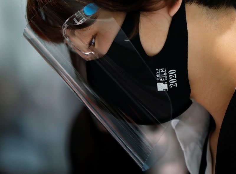 A staff member wearing a protective face mask and a shield is seen at an entrance gate before the opening ceremony of the 33rd Tokyo International Film Festival, amid the coronavirus disease (COVID-19) outbreak, in Tokyo