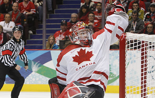 Canada's goalie Shannon Szabados and Marie-Philip Poulin celebrate