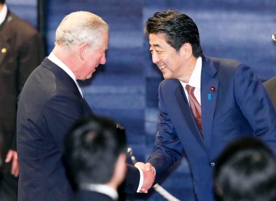Japanese Prime Minister Shinzo Abe shakes hands with Britain's Prince Charles