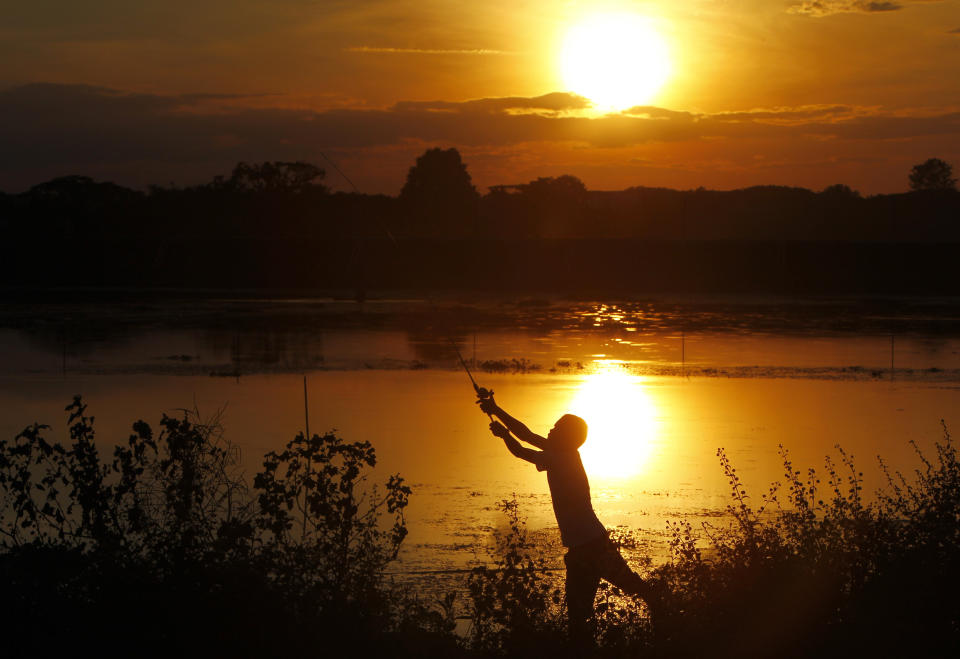 In this Monday, Dec, 3, 2018, file photo, a fisherman casts his line out on a lake during sunset in Naypyitaw, Myanmar, Monday, Dec, 3, 2018. (AP Photo/Aung Shine Oo, File)