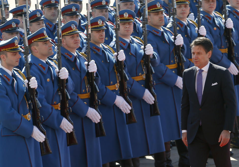 Italian Prime Minister Giuseppe Conte reviews the honor guard during a welcome ceremony ahead of meeting with his Serbian counterpart Ana Brnabic at the Serbia Palace in Belgrade, Serbia, Wednesday, March 6, 2019. Conte is on a one-day official visit to Serbia. (AP Photo/Darko Vojinovic)