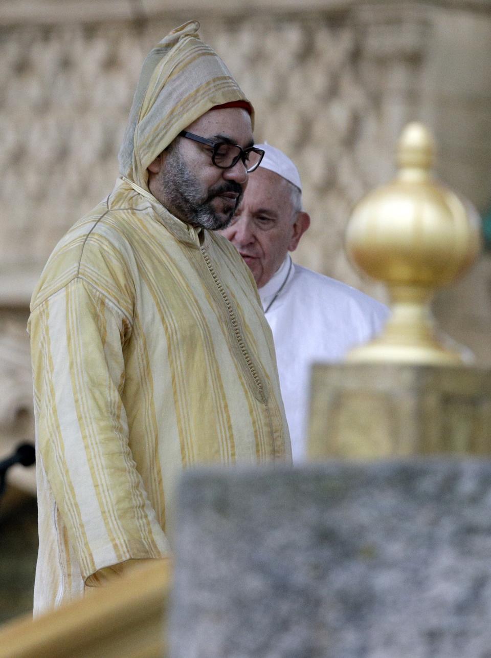 Pope Francis is flanked by Moroccan King Mohammed VI, in Rabat, Morocco, Saturday, March 30, 2019. Francis's weekend trip to Morocco aims to highlight the North African nation's tradition of Christian-Muslim ties while also letting him show solidarity with migrants at Europe's door and tend to a tiny Catholic flock on the peripheries. (AP Photo/Gregorio Borgia)