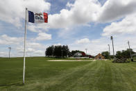 An Iowa flag waves in the wind over the field at the Field of Dreams movie site, Friday, June 5, 2020, in Dyersville, Iowa. Major League Baseball is building another field a few hundred yards down a corn-lined path from the famous movie site in eastern Iowa but unlike the original, it's unclear whether teams will show up for a game this time as the league and its players struggle to agree on plans for a coronavirus-shortened season. (AP Photo/Charlie Neibergall)